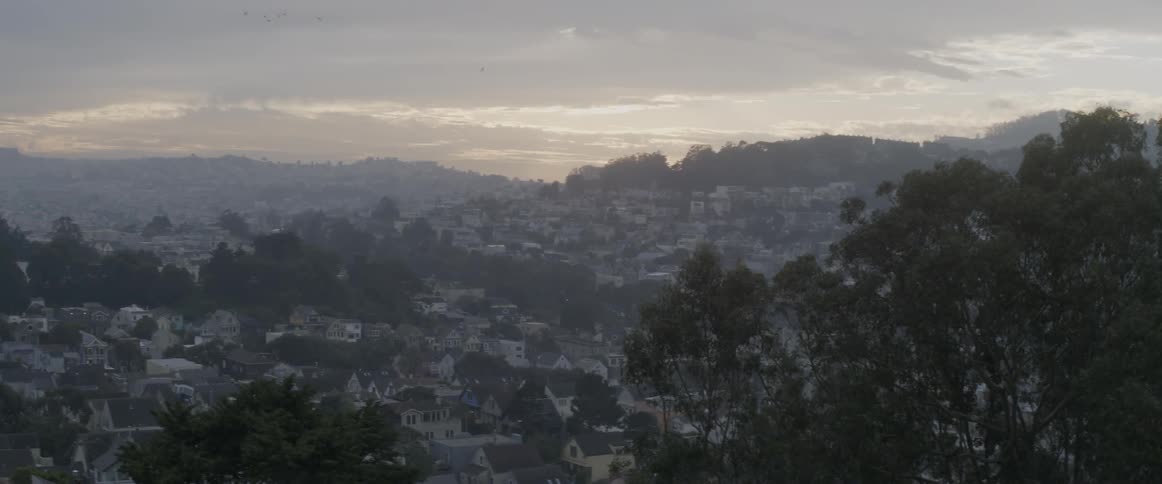 A hillside view of a village during a windy day