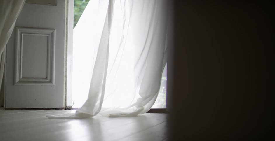 A curtain blows in this doorway