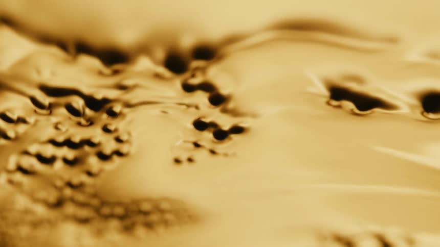 Abstract thick yellow liquid moves and creates holes flowing