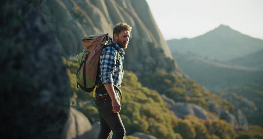 A man hikes in a mountain range