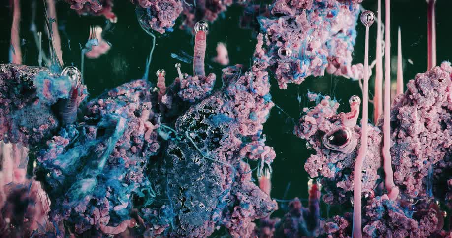 Strange organic growing blue and pink mass bubbling under water