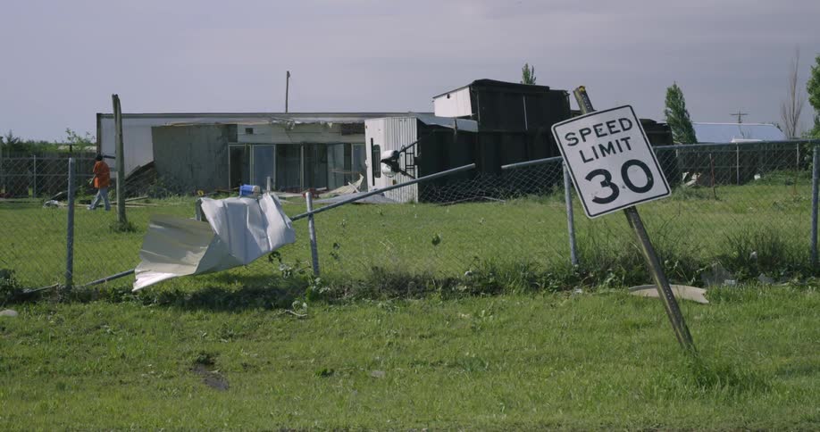 A person looking at storm debris