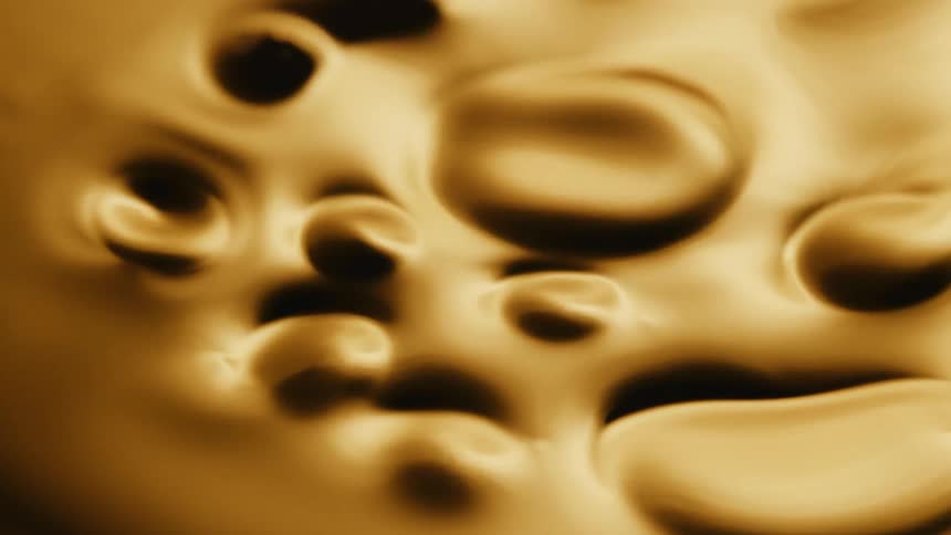 Close up of yellow thick liquid moving and flowing