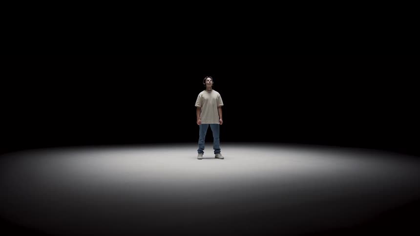 A person standing in a spotlight