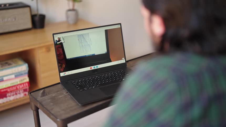 A man shares his computer screen over a video call with another man