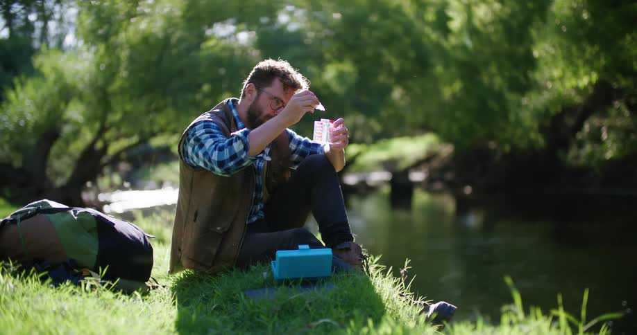A man uses a kit to test river water