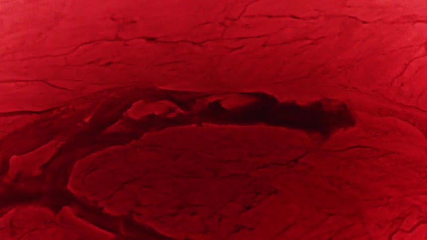 Liquid moves and splashes through a cracked red surface as pieces move and separate