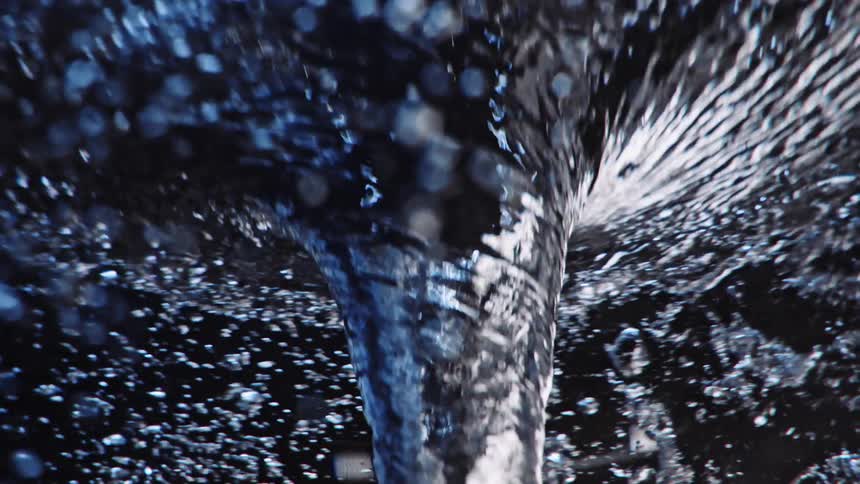 Water surrounded in bubbles spinning in a funnel