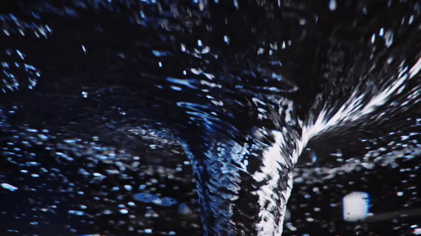 Liquid swirls in a counter clockwise cyclone as bubbles rise