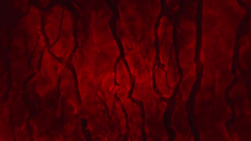 Red cracked surface objects break apart as water ripples and moves through the liquid