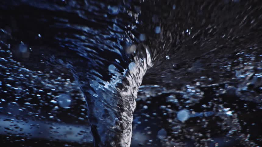 A vortex of liquid twists from left to right as bubbles float to the top