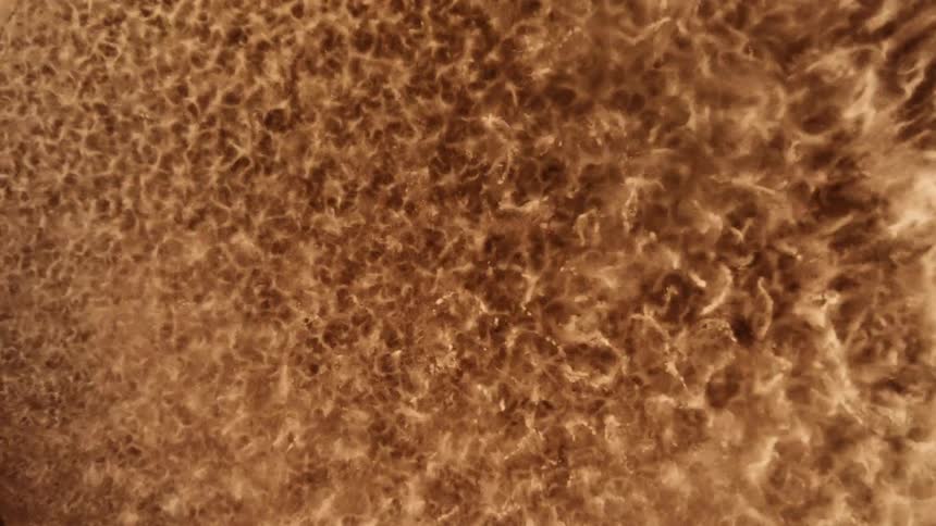 Close up top down view of the vibration patterns on a surface covered with sand