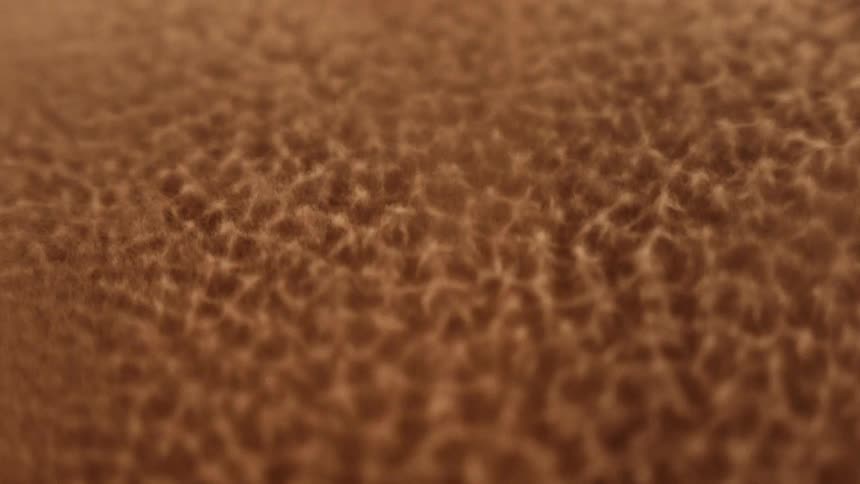 A vibrating light shines on a gold surface and it boils and splashes as the strobe flashes then melts back down