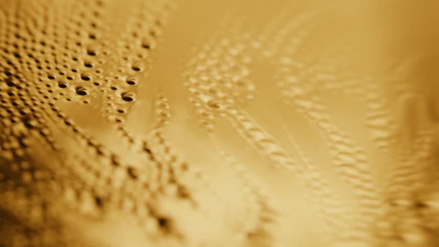 Bubbles from on the surface of a gold metal liquid