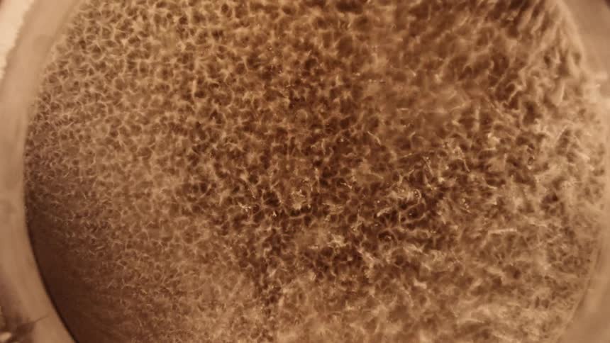 Close up top down view of the vibration patterns on a surface covered with sand