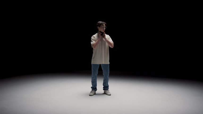 A teenager puts on his headphones