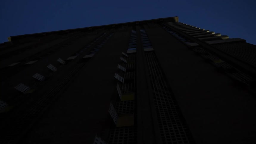 The view is of the city area at night time and you can see a building