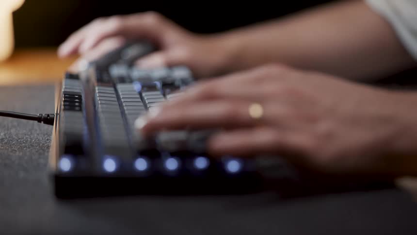 There is someone that is typing something on the keyboard inside of there home