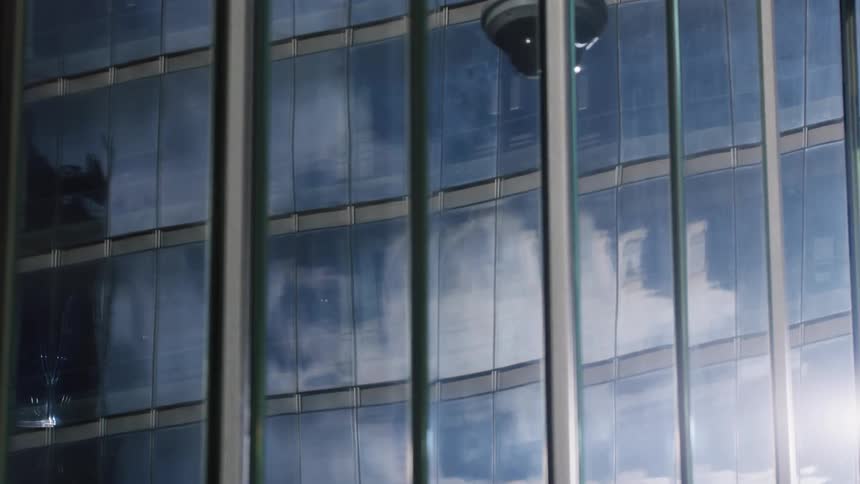 Clouds floating in the sky are reflected on building windows