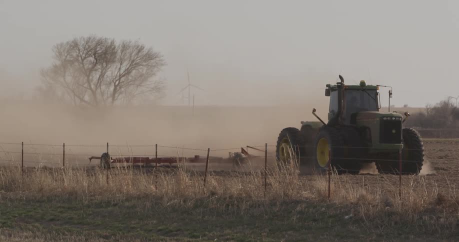 A tractor tilling a field