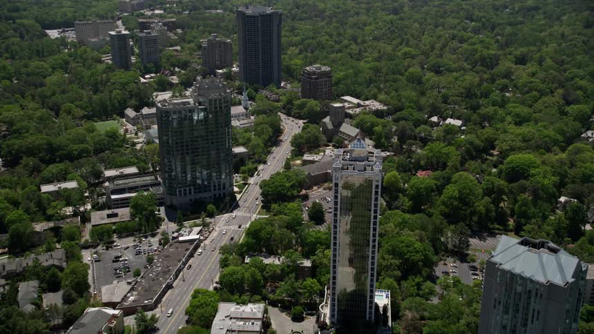 Approaching 2828 Peachtree a glass high rise in Buckhead Georgia from a birds eye view on a sunny day in summer