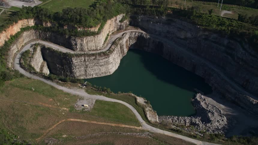 Aerial footage of a quarry in Atlanta Georgia shot during daytime featuring an orbiting view of the industrial area