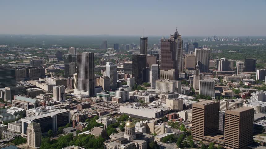 Flying over State Capitol and skyscrapers in Downtown Atlanta during a sunny day