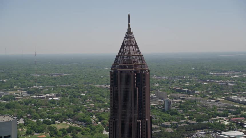 A breathtaking aerial view of Bank of America Plazas top as the camera orbits around the skyscraper situated in Midtown Atlanta Georgia