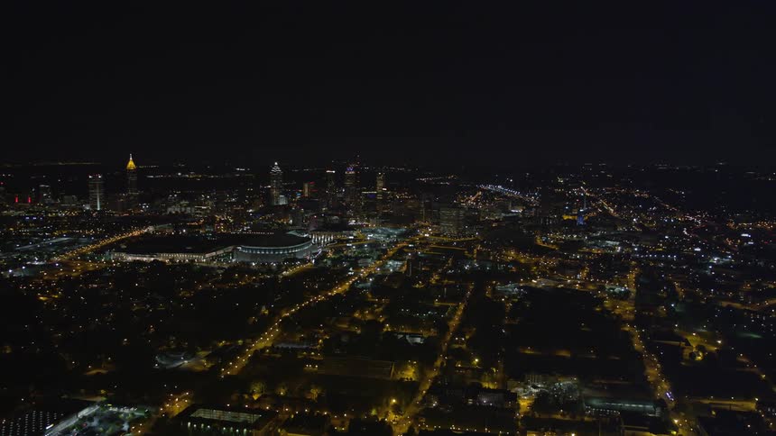 A stunning aerial view of Atlantas downtown area at night with tall skyscrapers lit up and glittering like jewels