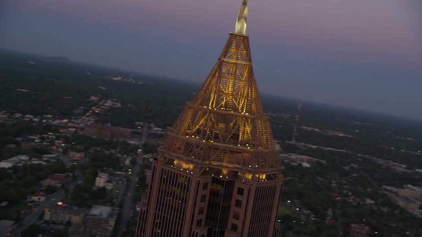 Close-up aerial footage of the top of Bank of America Plaza at twilight in Midtown Atlanta