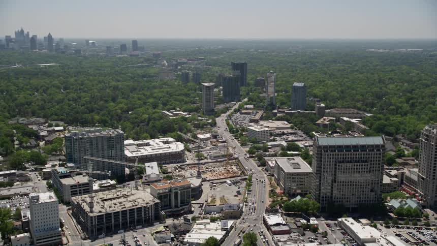 An aerial view of downtown Atlantas skyline including tall skyscrapers and office buildings captured during a sunny day in the summer