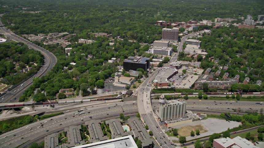 An aerial view of Buckhead Georgia reveals office buildings as the camera pans across freeways and expressways during the daytime