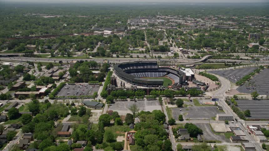 Aerial footage of Turner Field Atlantas MLB stadium captured during the daytime with an orbiting view while showing empty parking lots and nearby highway traffic passing by