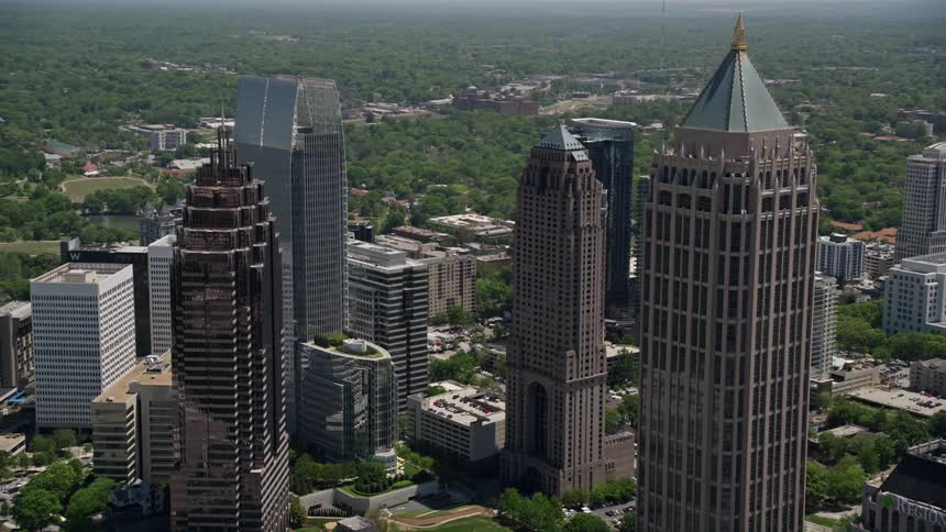 Fly over the towering skyscrapers of Midtown Atlanta Georgia on a sunny day in this aerial stock footage