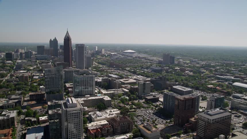 Aerial footage of Midtown and Downtown Atlantas skyscrapers including the Georgia Institute of Technology with light traffic on the busy streets below