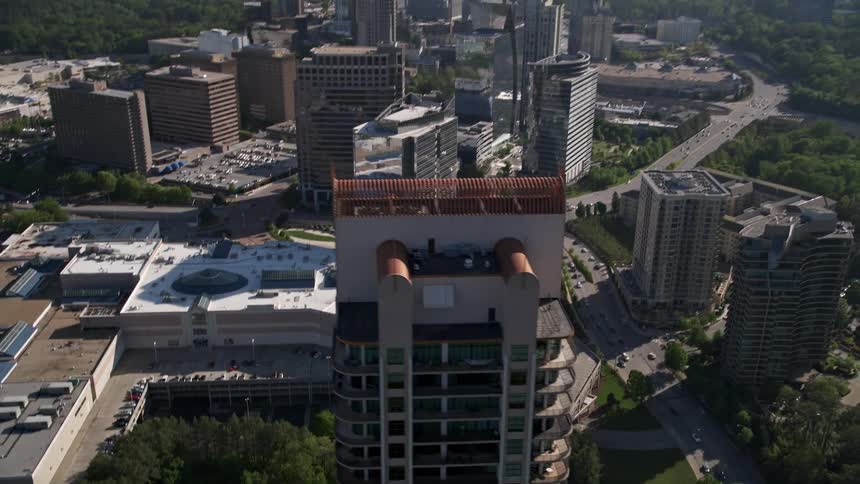 Aerial footage of Park Avenue Condos in Buckhead Georgia revealing the beautiful skyline of modern high-rise skyscrapers in the metropolitan area of Atlanta during a sunny day