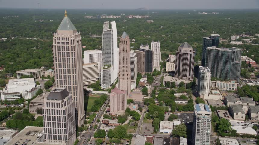An aerial approach and orbit of Midtown Atlanta skyscrapers during a sunny day in Georgia