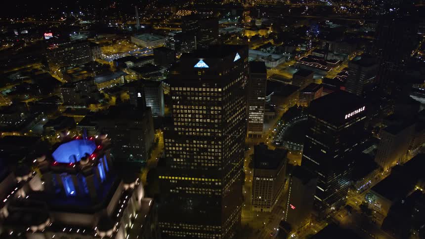 A nighttime aerial view of Downtown Atlantas skyscrapers and the State Capitol is captured as the camera flies over and between the tall buildings