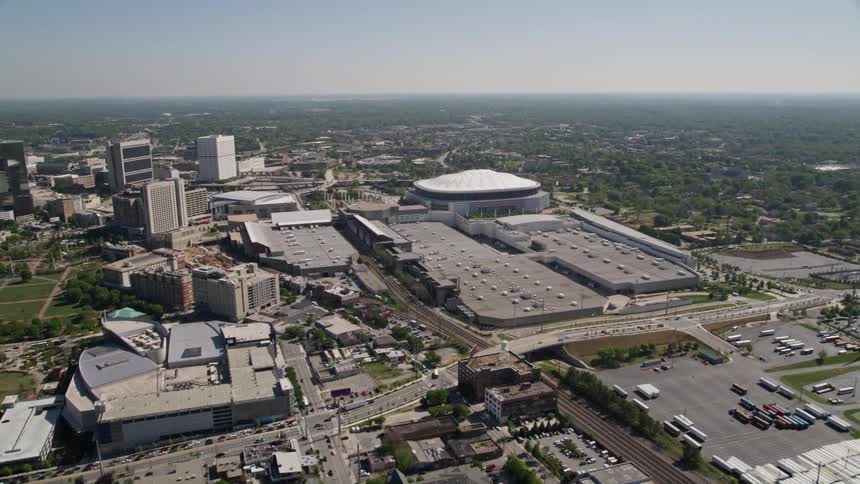 Aerial footage of a residential neighborhood with a tilt down to reveal the Georgia Dome stadium in downtown Atlanta
