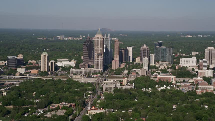 Approaching the towering skyscrapers of Midtown Atlanta during a sunny day