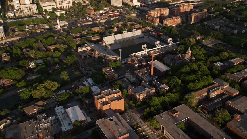 An aerial view capturing the skyline of Midtown Atlanta and Bobby Dodd Stadium during the bustling day time