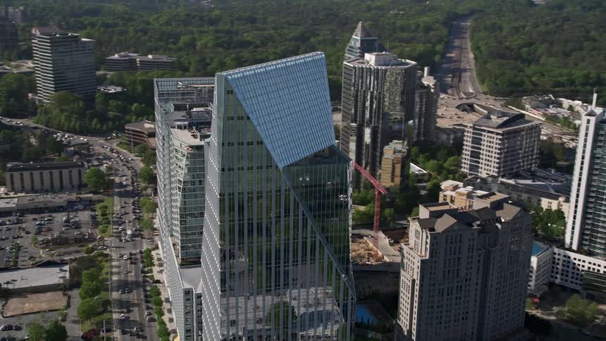 Aerial view of Atlanta Georgias skyline showing the citys towering skyscrapers and modern buildings on a sunny day