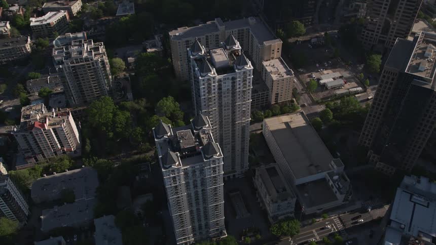 Aerial footage of a modern condominium complex in Midtown Atlanta tilting down to a birds eye view