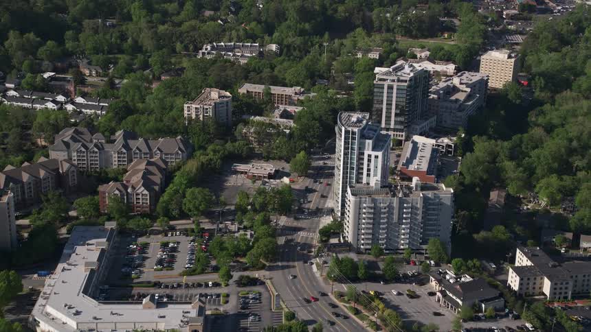 Aerial view of city road passing office and apartment buildings in Buckhead Georgia on a sunny day