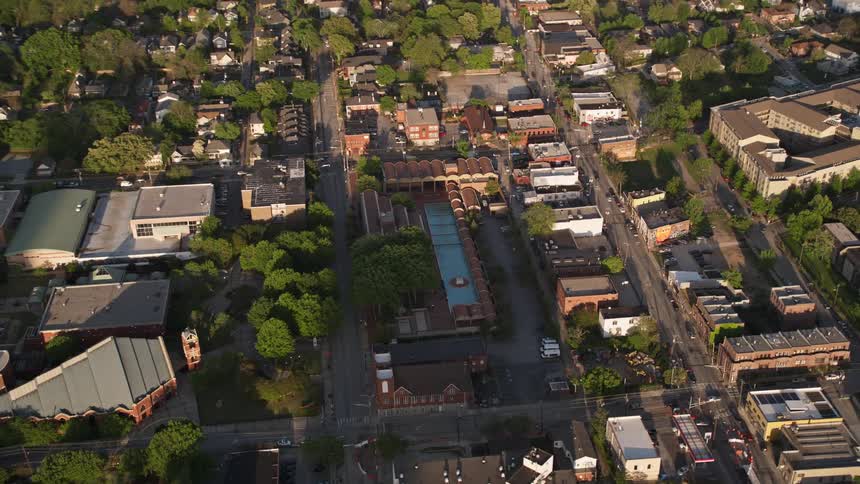 Orbiting aerial footage captures Martin Luther King Jr National Historic Site featuring the memorial fountain and surrounding buildings in Atlanta Georgia during daytime