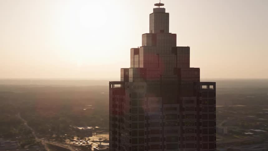Aerial footage of the sunset over the top of SunTrust Plaza in downtown Atlanta while orbiting the building