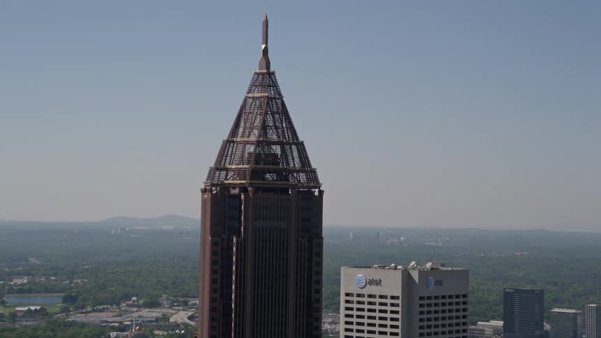 A medium shot aerial view of Bank of America Plaza approaching in midtown Atlanta on a sunny day