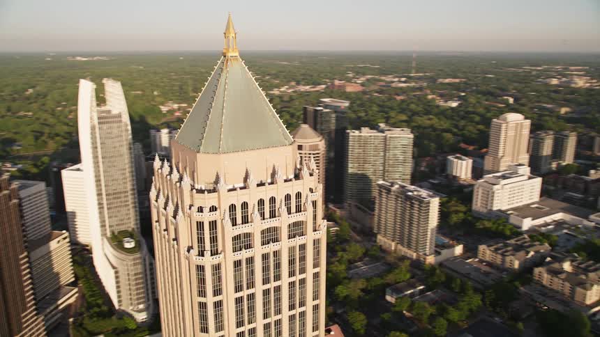 Approaching and orbiting One Atlantic Center to reveal more of Midtown Atlanta Georgia during sunset time