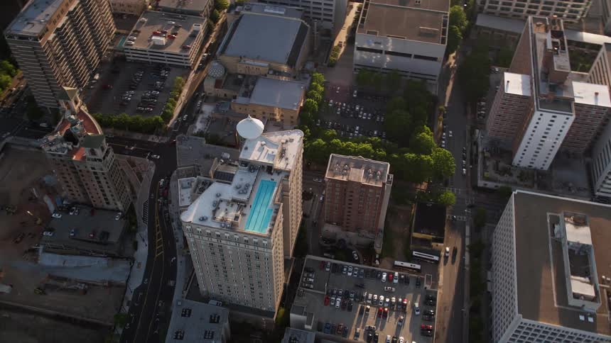 A spectacular aerial shot of Georgian Terrace Hotel as viewed from above in the midst of Midtown Atlanta during the day