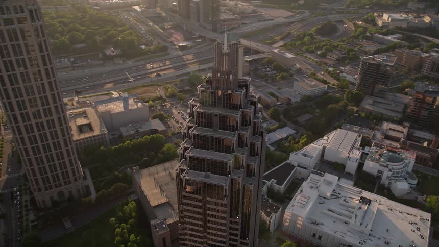 Aerial footage of Midtown Atlantas Promenade II building orbiting to reveal a cluster of skyscrapers